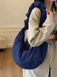 Quilted blue nylon hobo cloud bag with ruffled shoulder strap and puffy large capacity