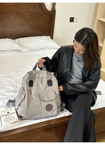 Detail view of large capacity nylon backpack with multiple zipper pockets for travel use