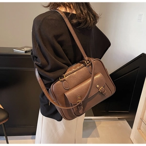Detail of vintage brown PU leather backpack with bronze buckles and retro flap pocket