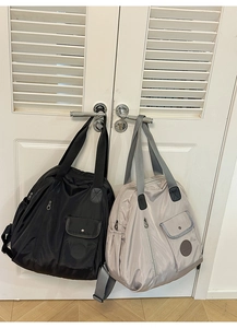 Detail showing high-capacity nylon tote bags in black and grey with functional multi-pockets