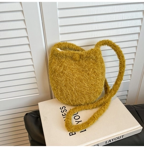 Detailed view of ginger yellow fluffy wool texture and strap on soft winter bucket bag