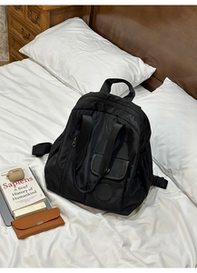 Detail of waterproof black nylon backpack showing smooth texture and large capacity