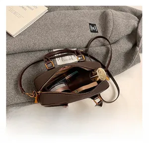 Interior view of brown leather bag showing storage for cosmetics and essentials