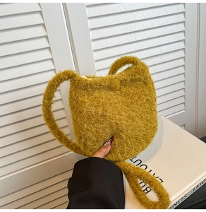 Detail shot of the ginger yellow plush bucket bag featuring soft fuzzy wool texture