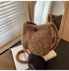 Detailed view of coffee brown wool bucket bag with plush animal ear design and soft texture