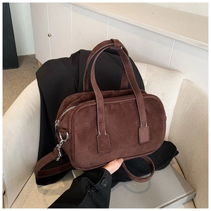 Detailed close-up of dark brown matte texture tote bag with silver hardware and stitching