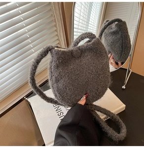 Close-up of gray plush wool shoulder bag with soft fuzzy texture for autumn and winter