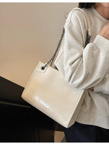 Chic beige quilted tote bag with chain strap and V-stitch pattern for casual daily wear