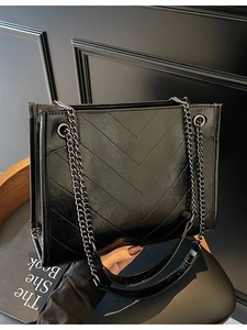 Black quilted tote bag with V-shaped stitching and metal chain strap for daily casual use