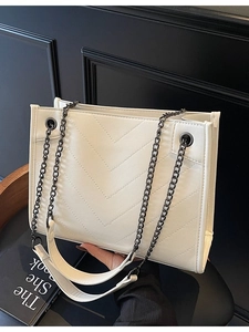 White quilted tote bag with V-shaped stitching and dark metal chain strap for women