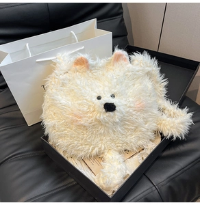 Detailed view of plush white puppy bag with fluffy faux fur texture in a gift box