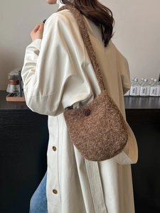 Brown fuzzy woolen bucket bag for women with button closure and shoulder strap