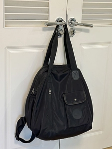 Versatile black waterproof nylon backpack for travel and daily commute with multi-way straps