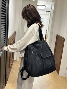 Large capacity black nylon backpack with adjustable wide straps for travel and commute