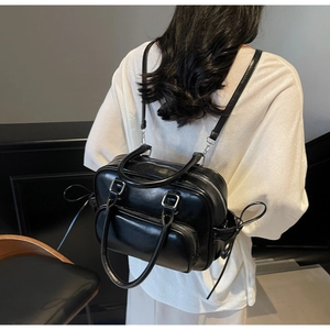 Close-up of black leather bowling bag showing silver hardware and drawstring side detail