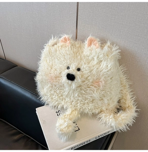 Detail of soft cream plush puppy bag showing fluffy texture and cute embroidered face