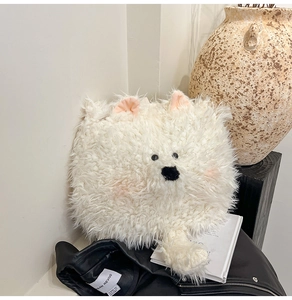 Detailed view of the soft white faux fur puppy bag with cute 3D pink ears and tail