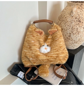 Détail du sac chat en peluche orange avec fourrure douce et poignées en cuir marron