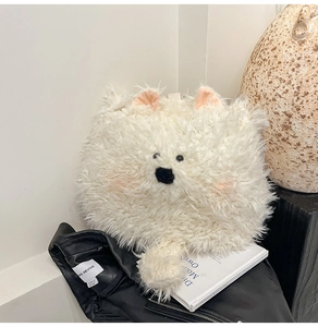 Detail of plush white dog-shaped bag with soft faux fur texture and cute pink inner ears