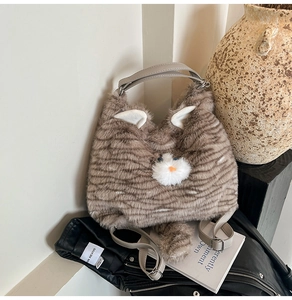 Détail du sac chat en peluche montrant la fourrure tigrée et la bandoulière en cuir