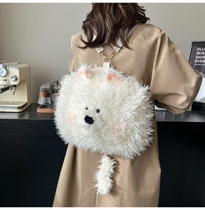 Detail of cute white plush Samoyed dog backpack with fluffy texture and tail charm