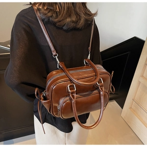 Detail showing deep brown vintage backpack mode with adjustable straps and multiple zippers