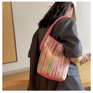 Detail einer bunten gewebten rosa Beuteltasche mit Streifen an der Schulter getragen