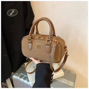 Detail view of brown vintage Boston bag with gold hardware and leather shoulder strap