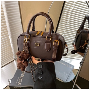Brown vintage leather Boston bag with gold dual zippers and a cute teddy bear charm