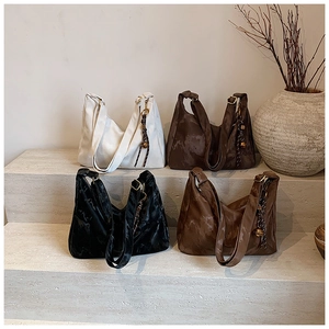 Detailed display of vintage large tote bags in four colors on a stone staircase