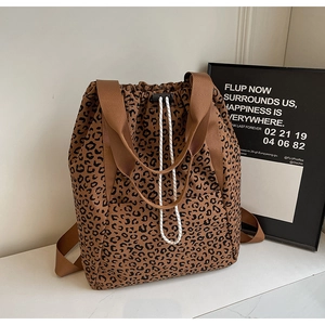Macro detail of leopard print tote bag fabric with drawstring and nylon handle