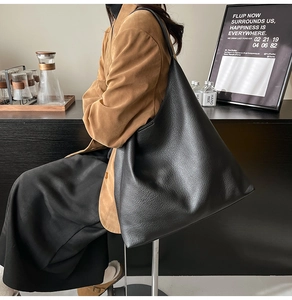 Detail of black pebbled leather tote bag with soft texture for office and daily commute