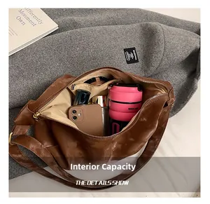 Internal capacity of large dark brown leather tote bag showing daily essentials