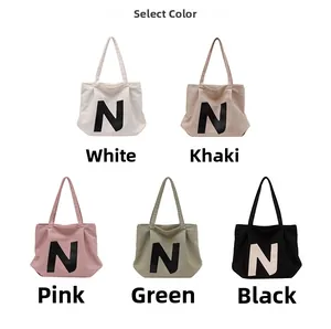 Canvas tote bag color options in white, khaki, pink, green, and black with N letter print