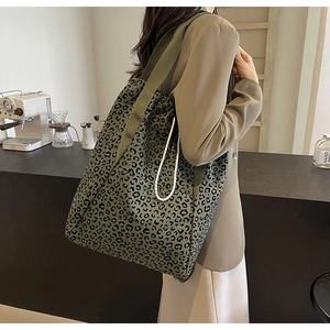 Detail of large leopard print tote bag with wide olive green straps and drawstring