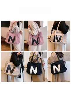 Detailed views of multi-color canvas tote bags with N logo and shoulder strap