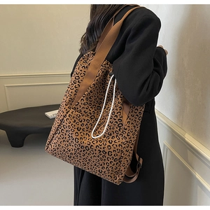 Lifestyle shot of model carrying a large leopard print canvas tote bag with drawstring
