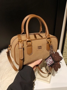 Vintage brown Boston bag with plush bear charm, versatile shoulder and crossbody style