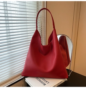 Detail of red pebbled leather hobo tote showing soft texture and integrated strap
