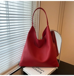 Macro shot of red lychee textured tote bag featuring a minimalist hobo design for women