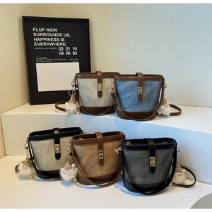 Detailed close-up showing five color variants of retro bucket bags with plush charms