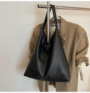 Detail view of black lychee grain texture on a large capacity minimalist tote bag