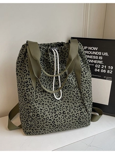 Fashionable leopard print drawstring tote bag shown from a 45-degree angle on marble