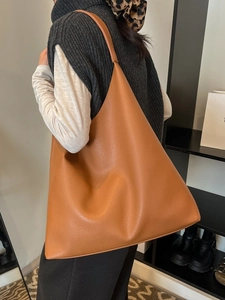 Minimalist brown pebbled leather tote bag with large capacity and wide shoulder straps