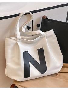 Large beige canvas tote bag with black N letter design for casual daily use and school
