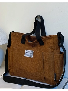 Brown corduroy tote bag with multiple pockets and adjustable shoulder strap for casual use