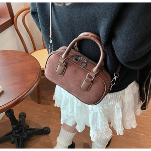 Detail of vintage brown suede Boston bag featuring dual zippers and leather trim