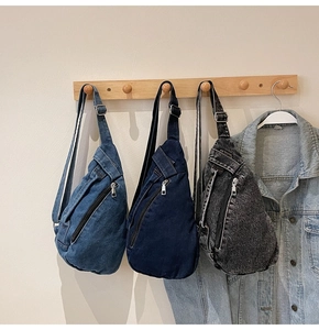 Three washed denim crossbody bags in light blue, dark blue, and charcoal grey tones