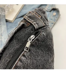 Detailed macro view of high-quality metal zipper on dark gray denim crossbody bag