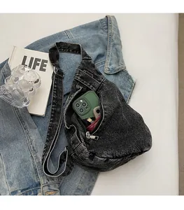 Interior view of denim crossbody bag showing spacious capacity for phone and wallet